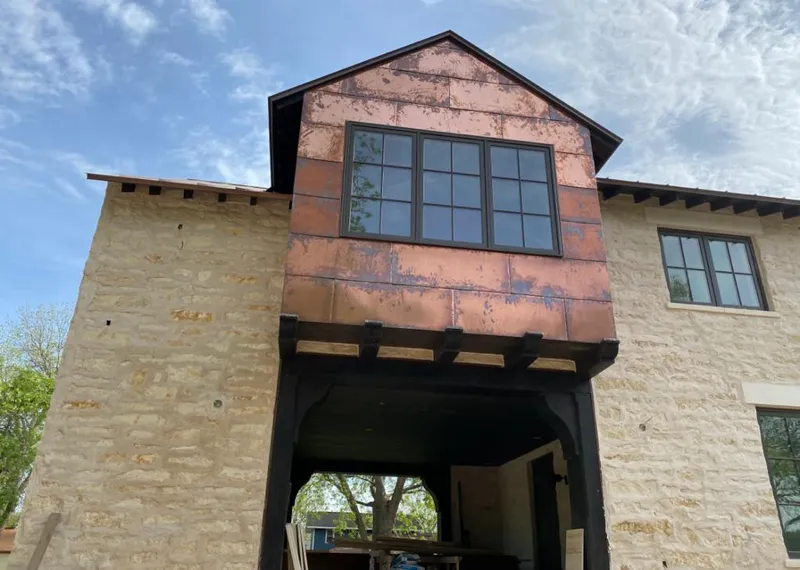 Copper metal panel facade on a stone building for Metal Roof Coating in Devils Lake
