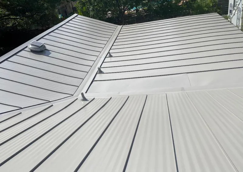 Solar attic fan installed on a metal roof for Roof Ventilation in Devils Lake